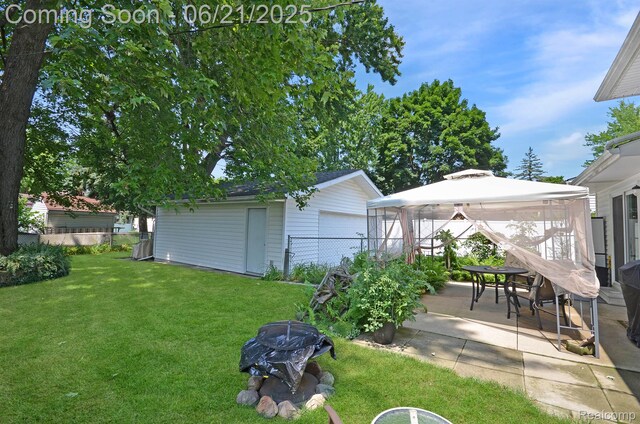 43475 Deborah Dr, Sterling Heights, MI 48313 - view of yard featuring a gazebo, a patio area, an outdoor structure, and a detached garage