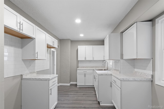 26908 Kitch St, Inkster, MI 48141 - kitchen with a sink, tasteful backsplash, dark wood-style flooring, white cabinetry, and recessed lighting