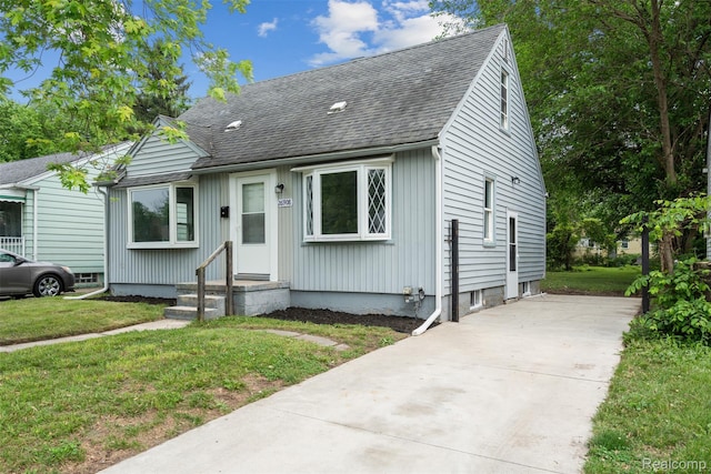 26908 Kitch St, Inkster, MI 48141 - view of front of house featuring a shingled roof, a front yard, and driveway