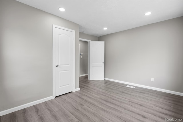 26908 Kitch St, Inkster, MI 48141 - unfurnished bedroom with baseboards, wood finished floors, and recessed lighting