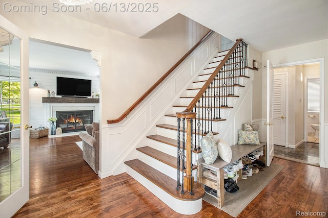 9875 Island Dr, Grosse Ile, MI 48138 - stairway with wood-type flooring, a glass covered fireplace, and baseboards