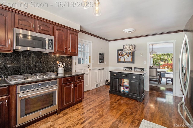 9875 Island Dr, Grosse Ile, MI 48138 - kitchen with appliances with stainless steel finishes, ornamental molding, dark wood finished floors, a chandelier, and tasteful backsplash