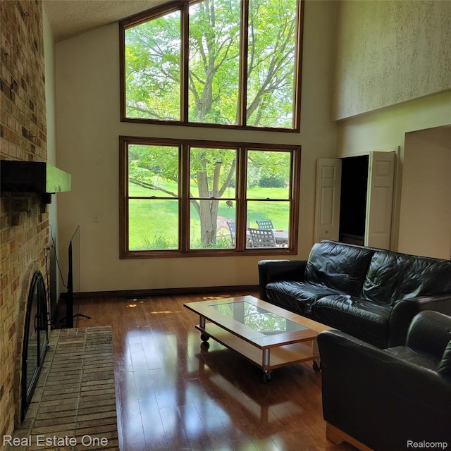 5208 Woodview Dr, Bloomfield Hills, MI 48302 - living area featuring a fireplace, hardwood / wood-style floors, and a towering ceiling