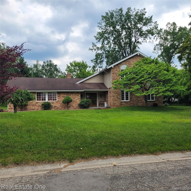 5208 Woodview Dr, Bloomfield Hills, MI 48302 - view of front of house with a chimney, a front yard, and brick siding