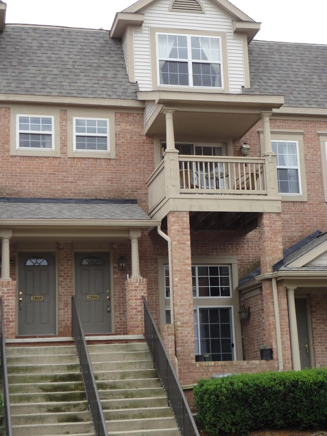 2856 Barclay Way, Ann Arbor, MI 48105 - view of front facade with a balcony, brick siding, and a shingled roof