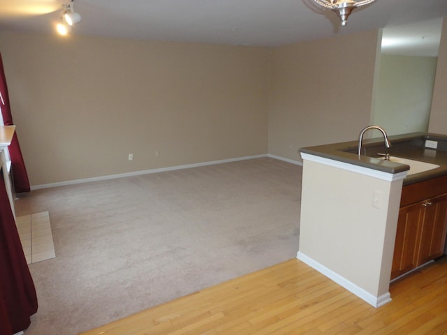 2856 Barclay Way, Ann Arbor, MI 48105 - kitchen with a sink, light wood finished floors, baseboards, and open floor plan