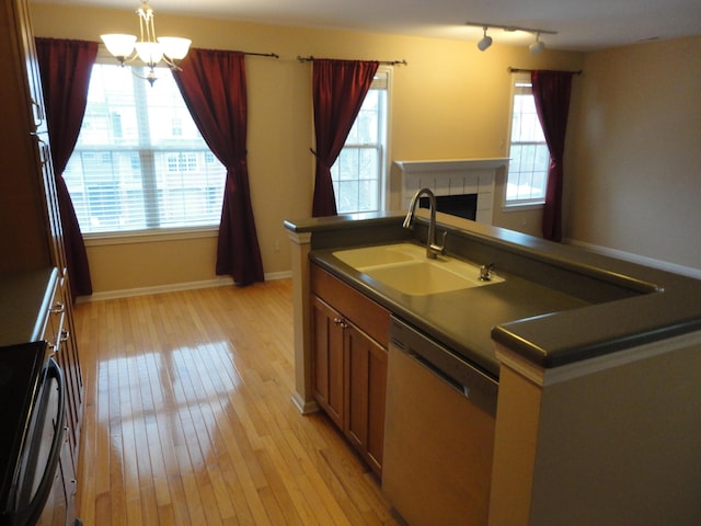 2856 Barclay Way, Ann Arbor, MI 48105 - kitchen with stainless steel dishwasher, a sink, dark countertops, a chandelier, and light wood-style floors