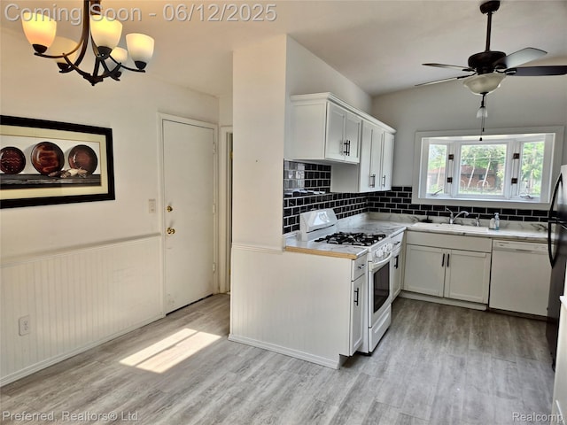 9498 Bassett St, Livonia, MI 48150 - kitchen with white appliances, a sink, light wood-style floors, white cabinets, and a wainscoted wall