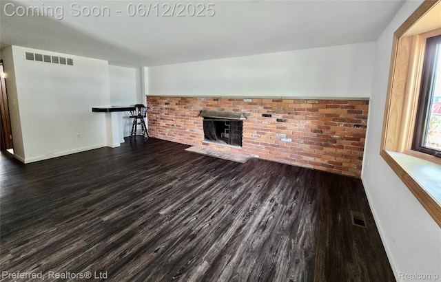 9498 Bassett St, Livonia, MI 48150 - unfurnished living room featuring wood finished floors, a brick fireplace, and baseboards