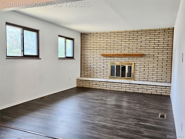9498 Bassett St, Livonia, MI 48150 - unfurnished living room featuring a brick fireplace and wood finished floors