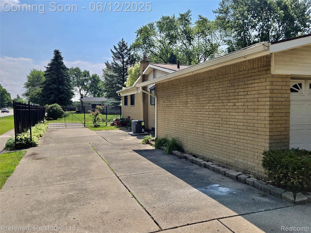 9498 Bassett St, Livonia, MI 48150 - view of property exterior featuring brick siding and a chimney