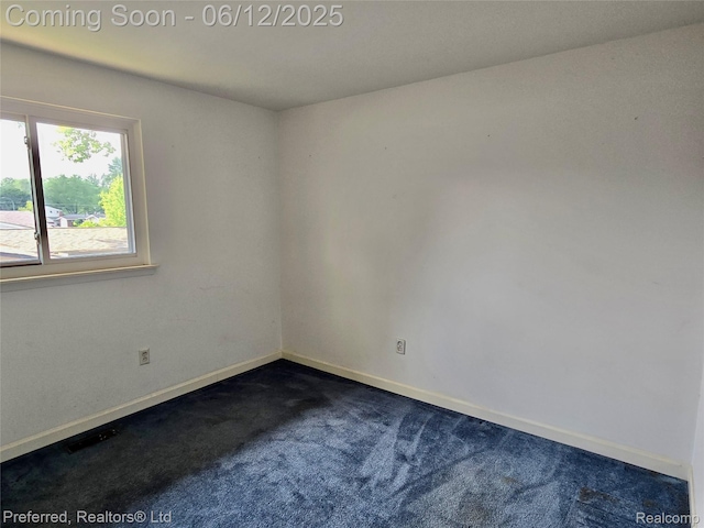9498 Bassett St, Livonia, MI 48150 - spare room with dark colored carpet and baseboards