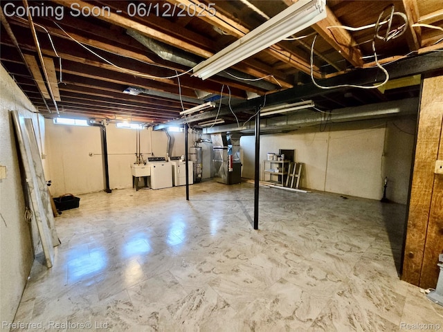 9498 Bassett St, Livonia, MI 48150 - below grade area with independent washer and dryer, heating unit, a sink, gas water heater, and tile patterned floors