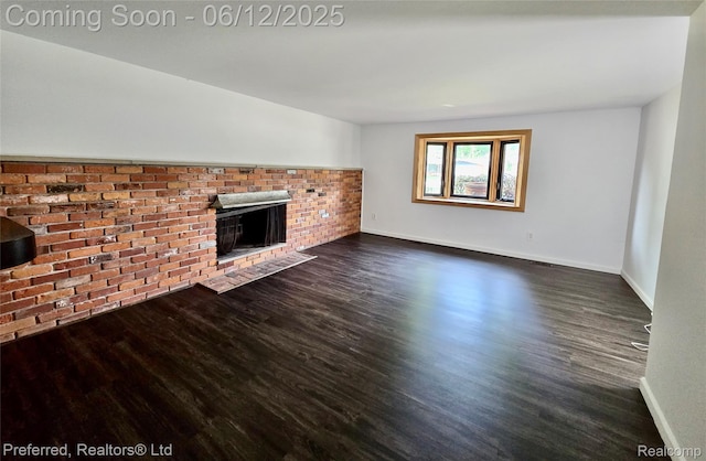 9498 Bassett St, Livonia, MI 48150 - unfurnished living room featuring dark wood-style floors and a brick fireplace