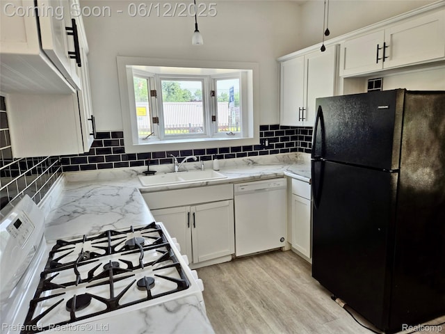 9498 Bassett St, Livonia, MI 48150 - kitchen with white appliances, white cabinetry, tasteful backsplash, light wood-type flooring, and light stone counters