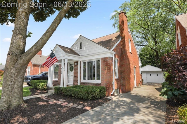 1630 N Denwood St, Dearborn, MI 48128 - view of front of property with brick siding, an outbuilding, a garage, and a chimney