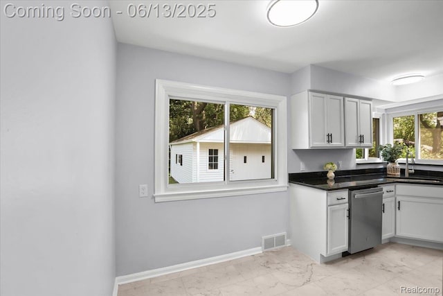 1630 N Denwood St, Dearborn, MI 48128 - kitchen with dishwasher, light marble finish flooring, dark countertops, and white cabinetry
