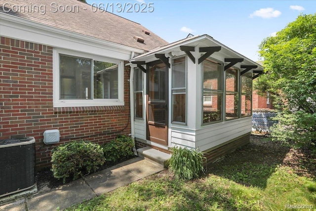 1630 N Denwood St, Dearborn, MI 48128 - view of side of home featuring brick siding, a sunroom, and a shingled roof
