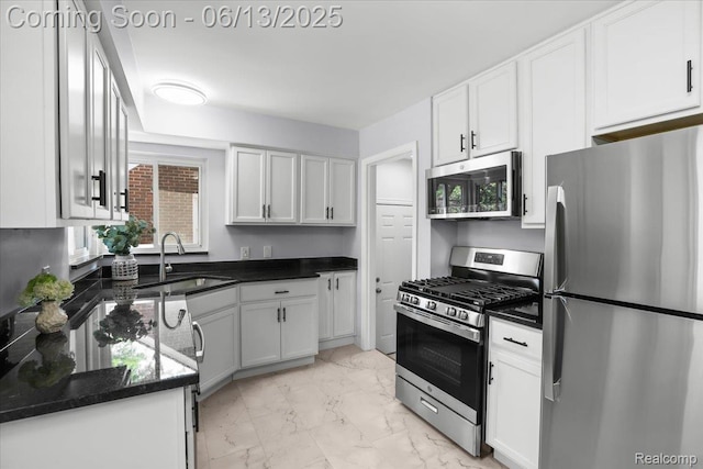 1630 N Denwood St, Dearborn, MI 48128 - kitchen featuring appliances with stainless steel finishes, light marble finish flooring, white cabinetry, and dark stone countertops