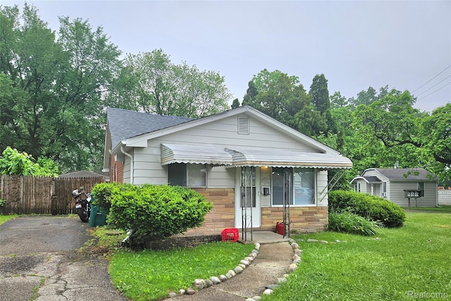 22100 Hawthorne St, Rochester, MI 48336 - bungalow-style house featuring a shingled roof and stone siding
