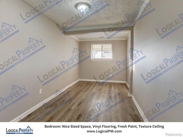 22100 Hawthorne St, Rochester, MI 48336 - unfurnished room with wood finished floors and baseboards