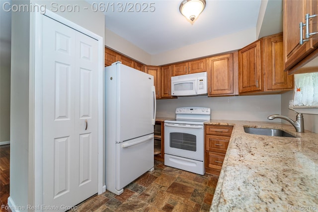 49904 Helfer Blvd, Wixom, MI 48393 - kitchen with white appliances, brown cabinets, light stone counters, and dark stone finish floors