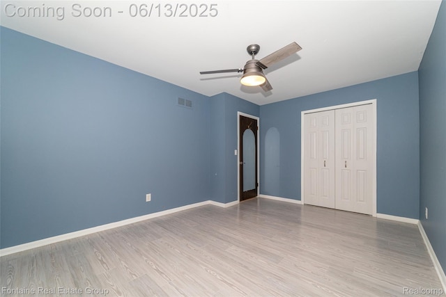 49904 Helfer Blvd, Wixom, MI 48393 - unfurnished bedroom with wood finished floors, a closet, and a ceiling fan