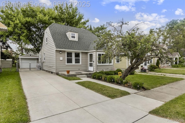 23083 Tawas Ave, Hazel Park, MI 48030 - view of front of house featuring an outbuilding, a detached garage, and a shingled roof