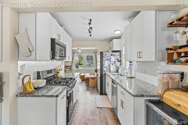 23083 Tawas Ave, Hazel Park, MI 48030 - kitchen with appliances with stainless steel finishes, wine cooler, light wood-style floors, and backsplash