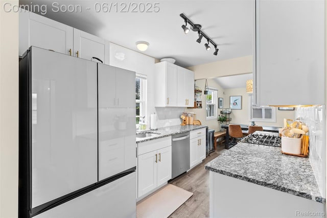 23083 Tawas Ave, Hazel Park, MI 48030 - kitchen with freestanding refrigerator, stainless steel dishwasher, white cabinets, light wood finished floors, and light stone countertops