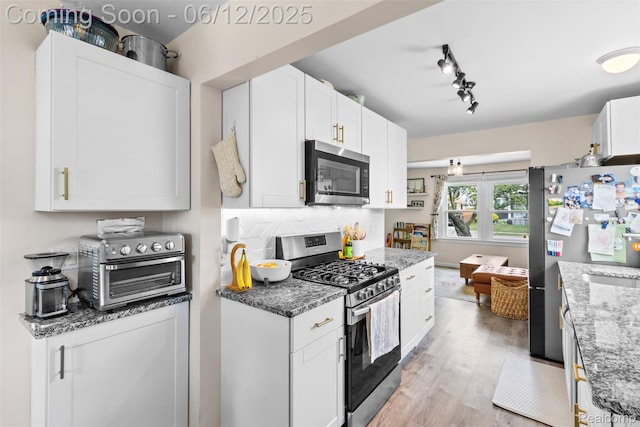 23083 Tawas Ave, Hazel Park, MI 48030 - kitchen featuring appliances with stainless steel finishes, white cabinets, light wood-style floors, and light stone counters