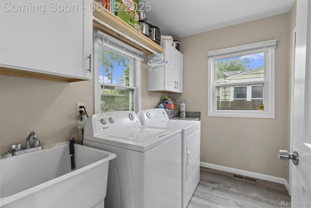 23083 Tawas Ave, Hazel Park, MI 48030 - laundry room featuring cabinet space, independent washer and dryer, and light wood-style floors