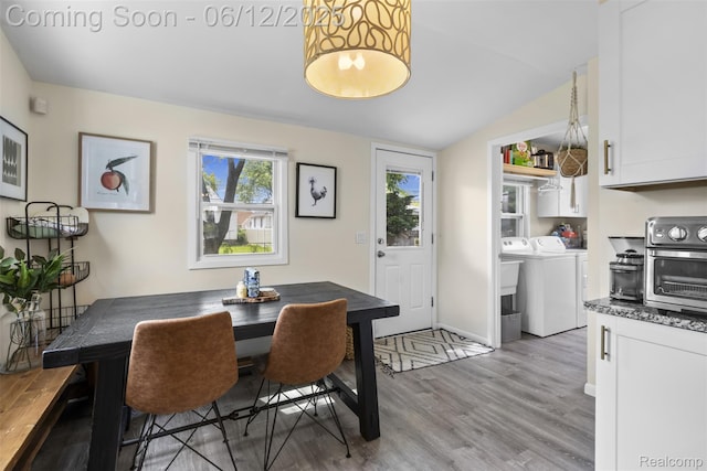 23083 Tawas Ave, Hazel Park, MI 48030 - dining area featuring washing machine and clothes dryer, light wood finished floors, and lofted ceiling