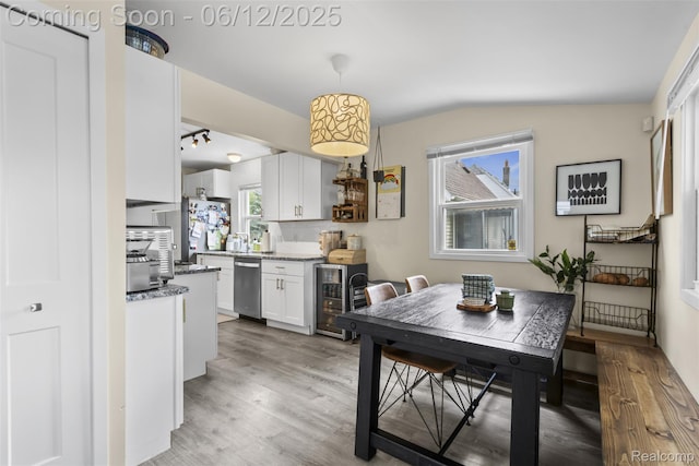 23083 Tawas Ave, Hazel Park, MI 48030 - dining room with beverage cooler, lofted ceiling, and light wood-style flooring
