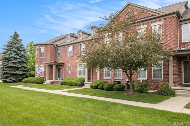 49761 Courtyard Ln, Canton, MI 48188 - colonial-style house featuring brick siding and a front lawn