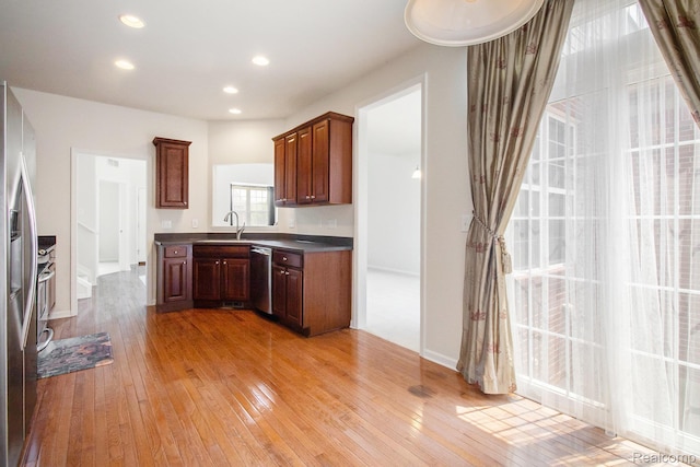 49761 Courtyard Ln, Canton, MI 48188 - kitchen featuring stainless steel appliances, light wood-type flooring, dark countertops, and recessed lighting