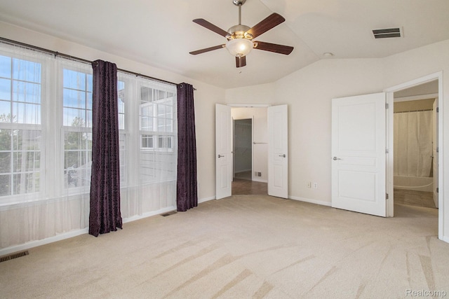49761 Courtyard Ln, Canton, MI 48188 - unfurnished bedroom with light colored carpet, lofted ceiling, and ceiling fan