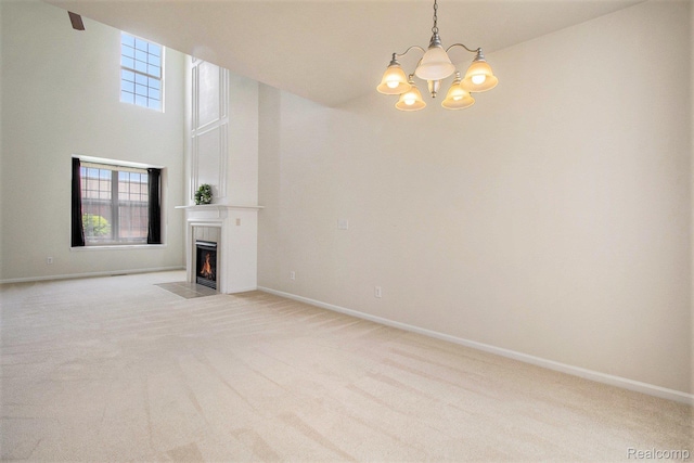 49761 Courtyard Ln, Canton, MI 48188 - unfurnished living room with light colored carpet, a fireplace with flush hearth, a chandelier, and a towering ceiling