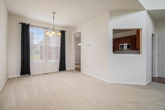 49761 Courtyard Ln, Canton, MI 48188 - empty room featuring a chandelier and light colored carpet