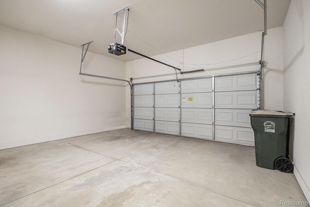 49761 Courtyard Ln, Canton, MI 48188 - garage featuring a garage door opener and baseboards