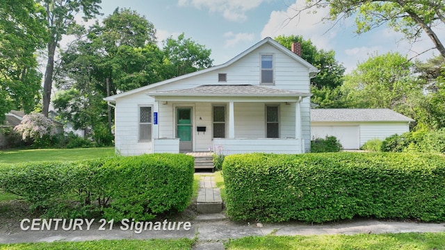 107 E Johns St, Durand, MI 48429 - view of front of property featuring a porch, a chimney, roof with shingles, and a garage