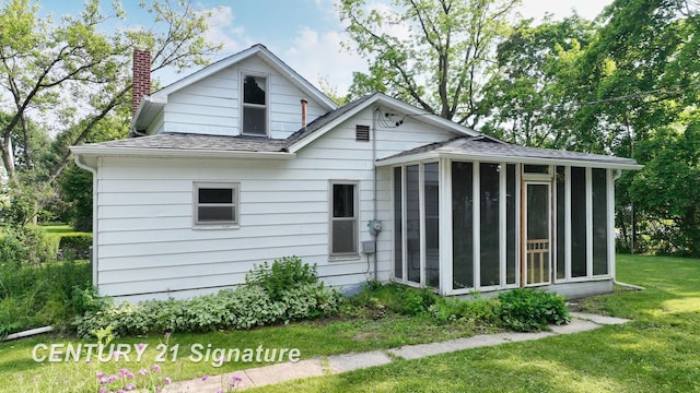 107 E Johns St, Durand, MI 48429 - view of front facade featuring a sunroom, a chimney, a shingled roof, and a front yard