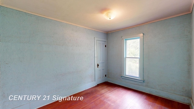 107 E Johns St, Durand, MI 48429 - empty room with wood finished floors, crown molding, and baseboards