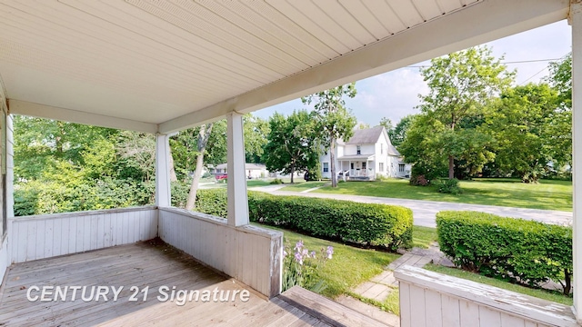 107 E Johns St, Durand, MI 48429 - wooden porch with a yard