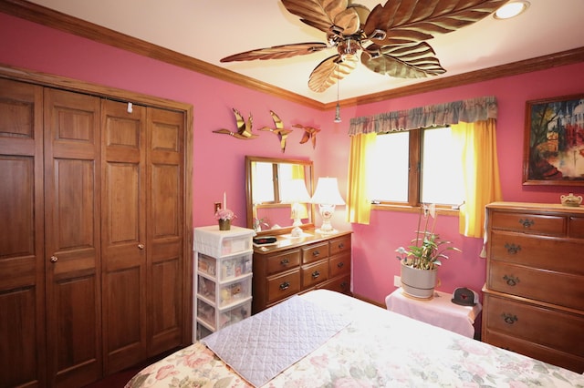 7484 Cedar Lake Rd, Oscoda, MI 48750 - bedroom featuring crown molding, ceiling fan, and a closet
