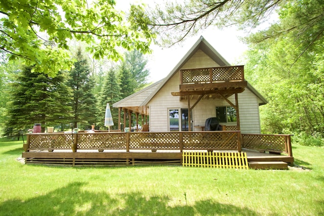 7484 Cedar Lake Rd, Oscoda, MI 48750 - rear view of house with a wooden deck, a yard, and a balcony