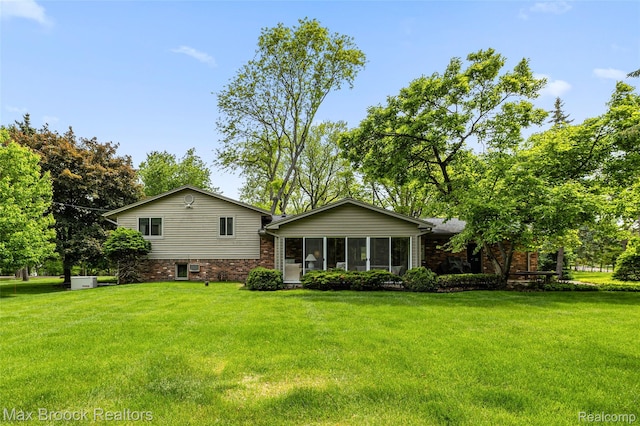 26480 Scenic Hwy, Franklin, MI 48025 - rear view of property featuring a yard, a sunroom, and brick siding