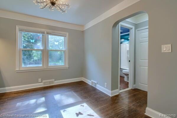25811 Briarbank Ave, Southfield, MI 48033 - empty room featuring arched walkways, wood finished floors, baseboards, and a chandelier