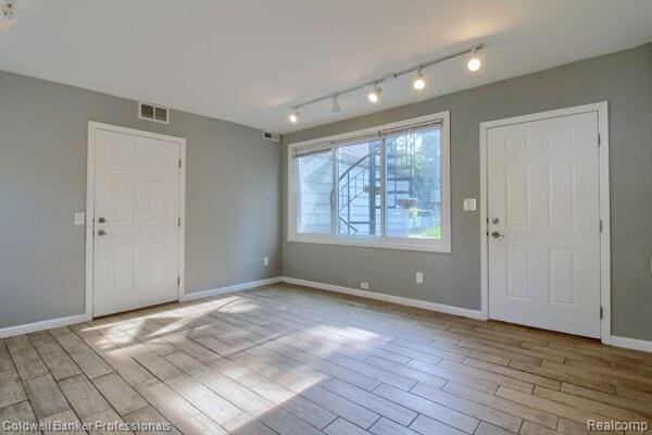 25811 Briarbank Ave, Southfield, MI 48033 - foyer featuring wood finished floors, baseboards, and track lighting