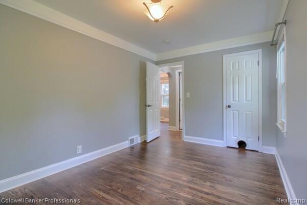 25811 Briarbank Ave, Southfield, MI 48033 - unfurnished bedroom featuring baseboards and dark wood-style flooring